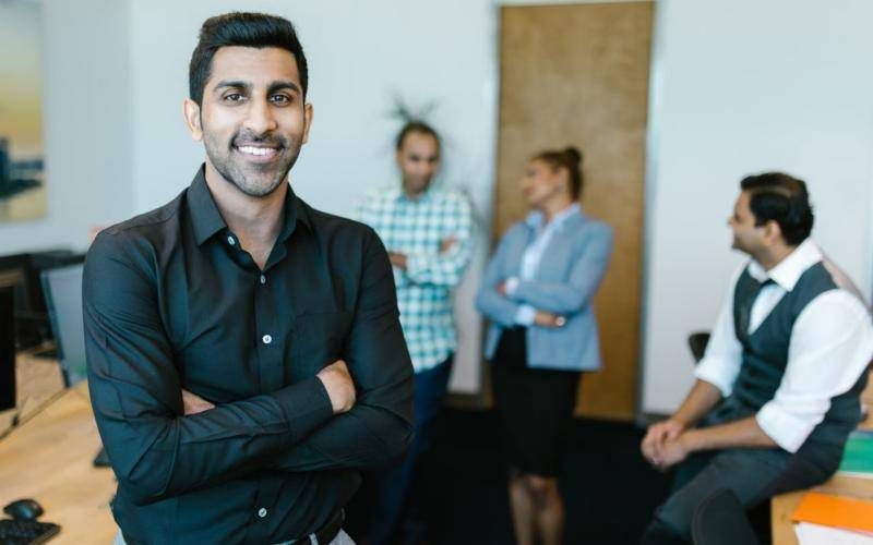 Business leader standing in front of his team