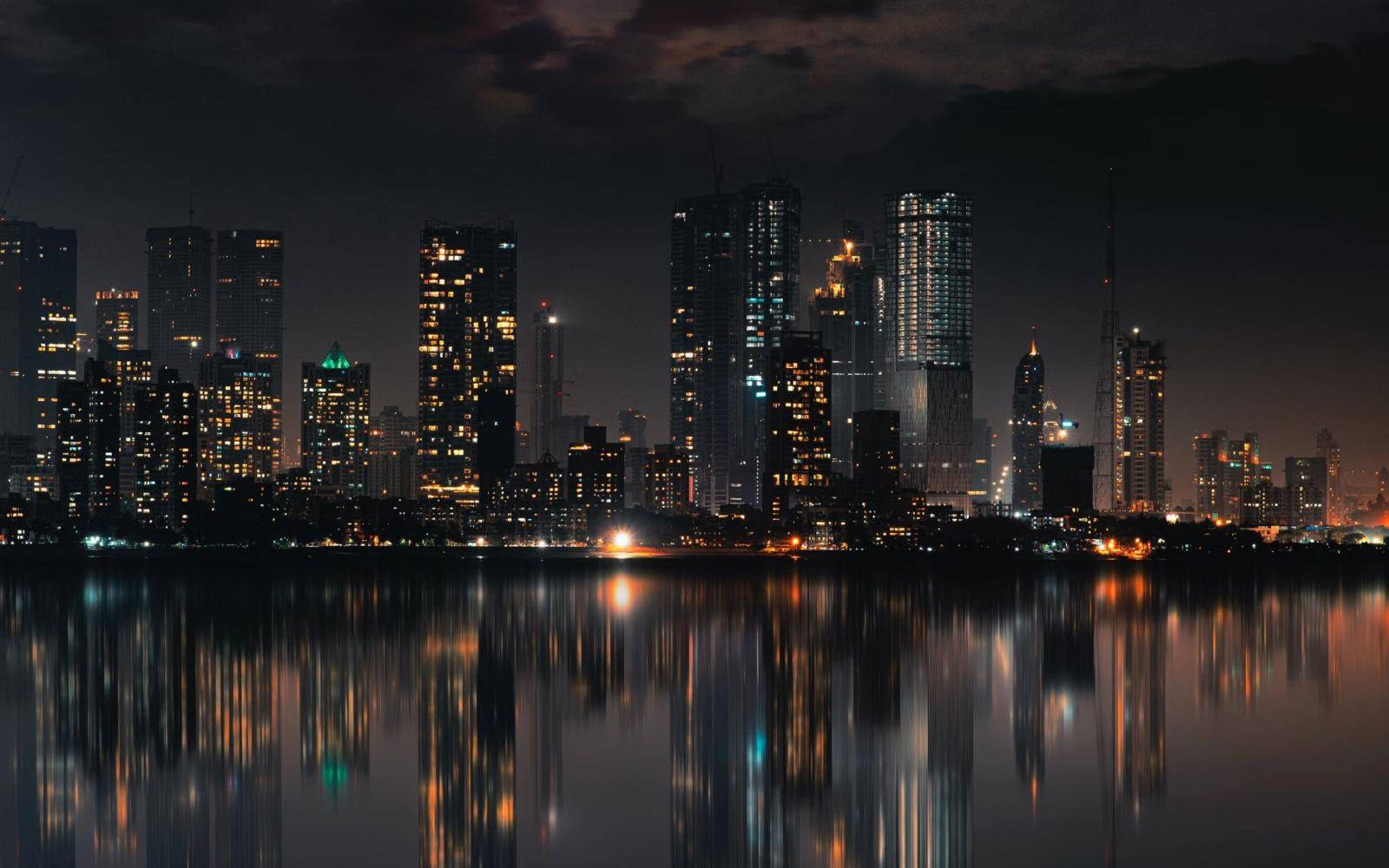 Mumbai skyline lit up at night over the water