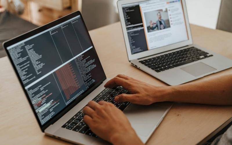 Developer writing code on a laptop