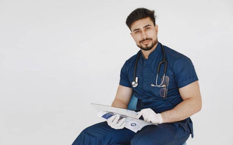 Doctor in scrubs reviewing a patient file