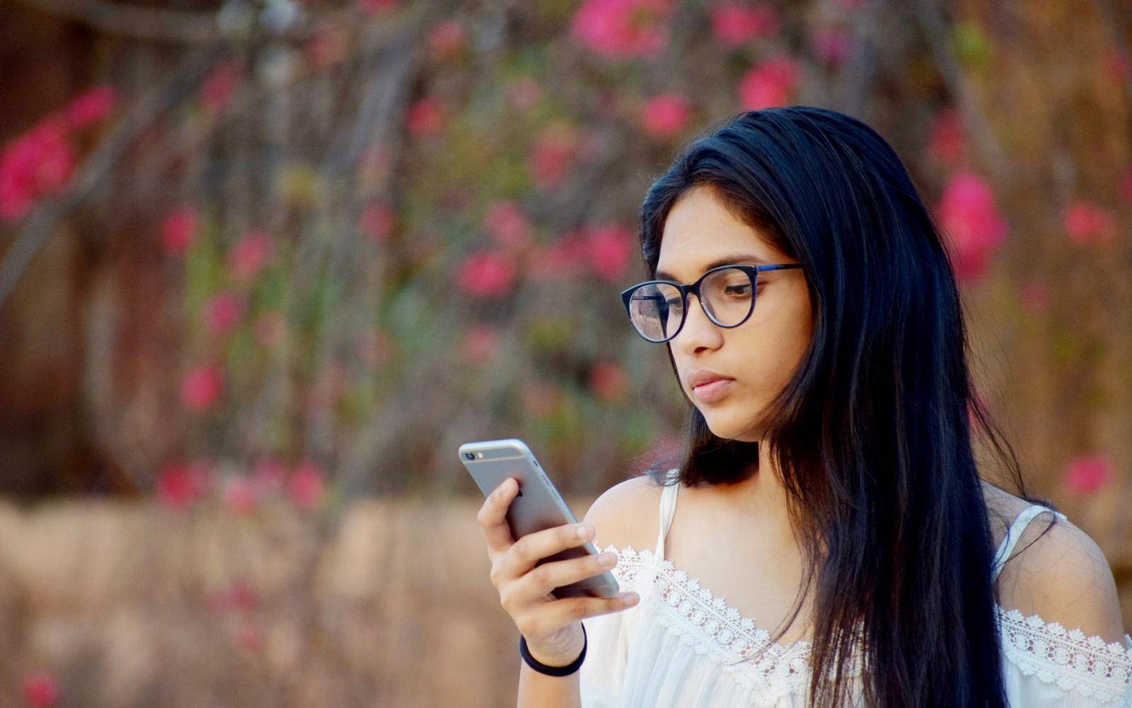 Young woman reading a message on her smartphone