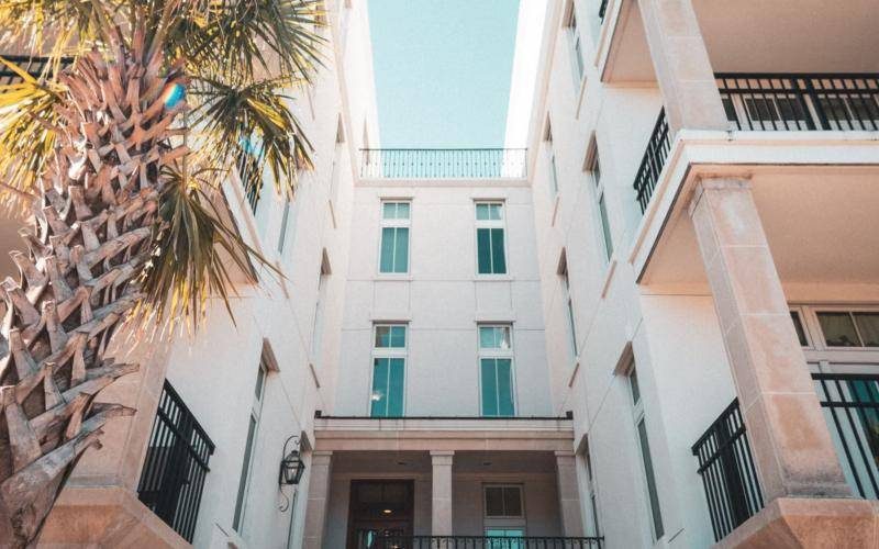 Hotel building with palm trees and balconies