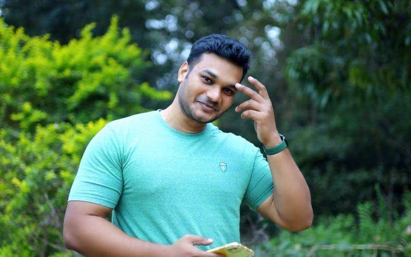 Young man holding his smartphone outdoors